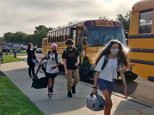 students getting off the bus
